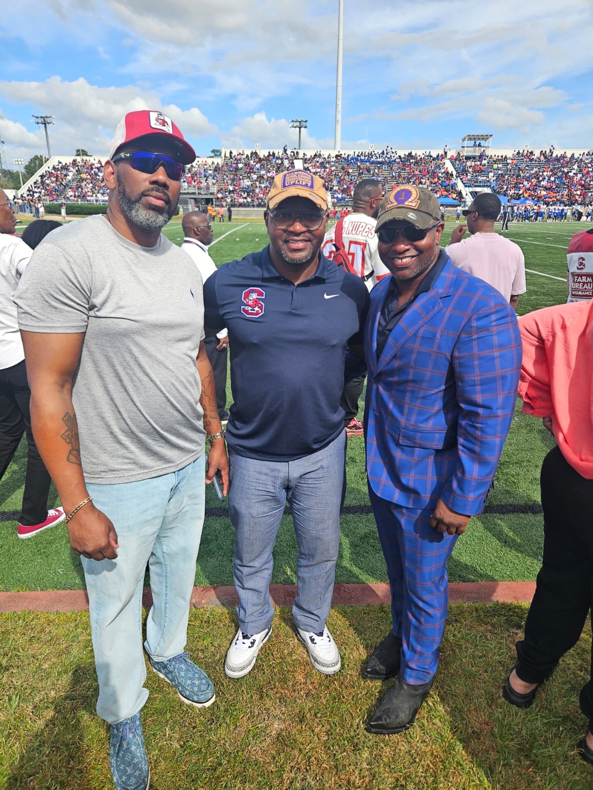 Three men at football field